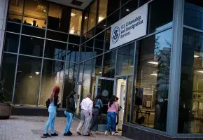 People enter Citizenship and Immigration Services in Fairfax, Va., on April 22, 2019.